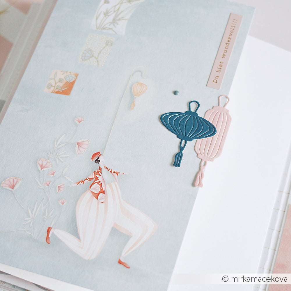 Eine skurrile Karte mit Laternen und Mustern, die mit dem Alexandra Renke Motivstanze Lampionset hergestellt wurde und eine illustrierte Figur in rosa und weißer Kleidung zeigt.