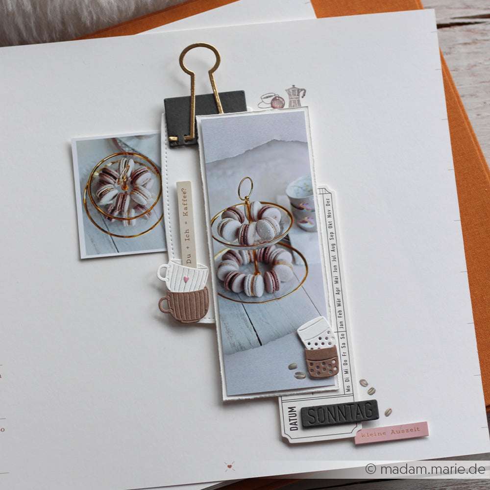 Scrapbook-Seite mit Fotos von einem Gugelhupf, einem Papierbecher und deutschen Textverzierungen auf weißem Papier, mit kreativen Akzenten, die mit Alexandra Renke Deep Edge Motivstanzen hergestellt wurden.