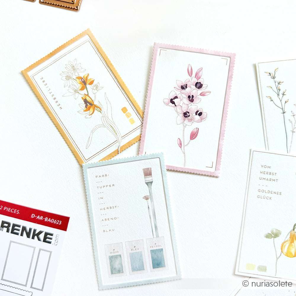 Vier illustrierte Karten mit floralen Motiven und Aquarellfarben, die mit Alexandra Renke PAPPcut®ies Deep Edge Motivstanzen und Motivstanze Briefmarken hergestellt wurden, sind wunderschön auf einer weißen Oberfläche angeordnet.