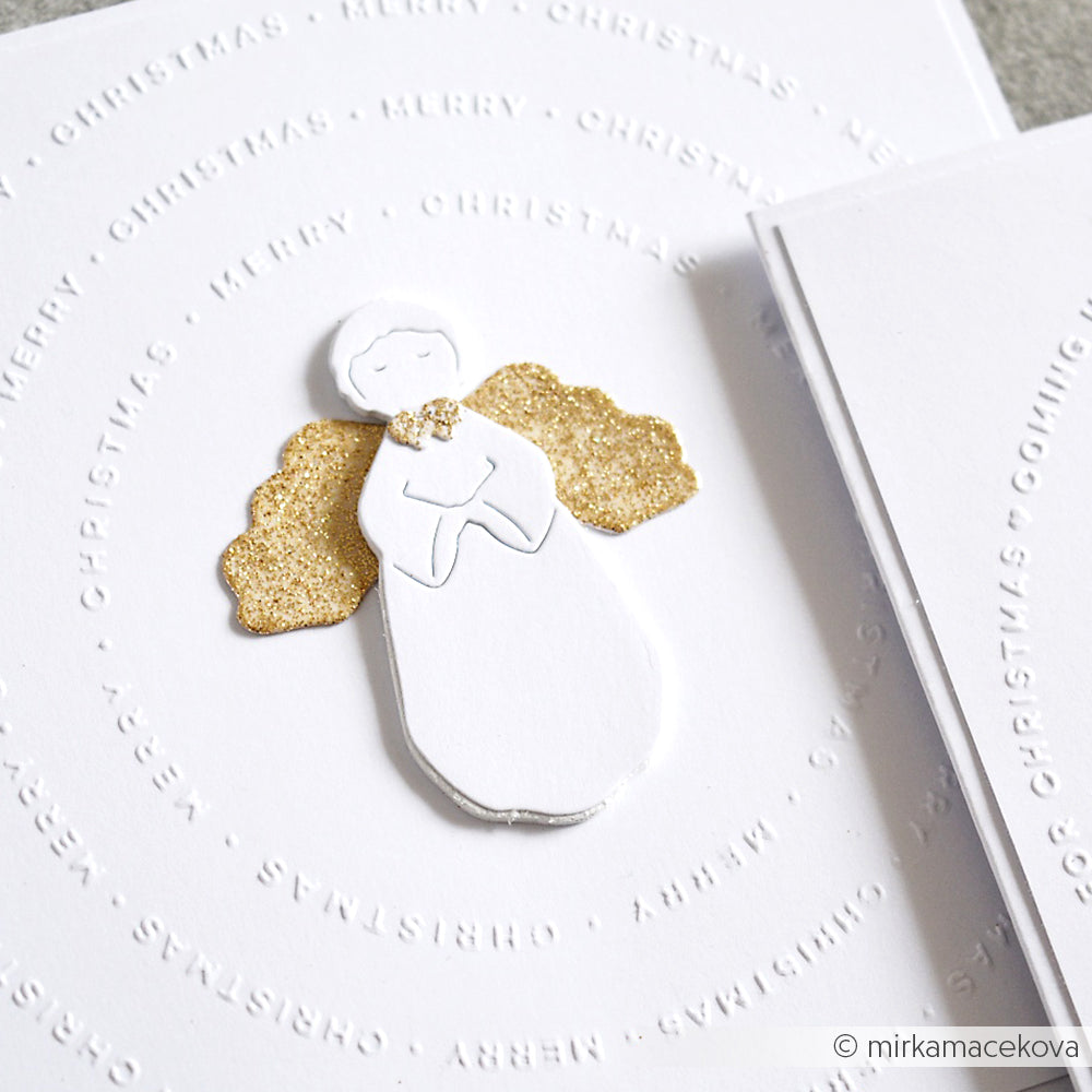 Handgefertigte Weihnachtskarte von Alexandra Renke mit einem weißen Engel mit glitzernden goldenen Flügeln, gefertigt mit der Motivstanze Sanfter Engel und eleganten Designpapieren, umgeben von einem festlichen "Merry Christmas" Text.