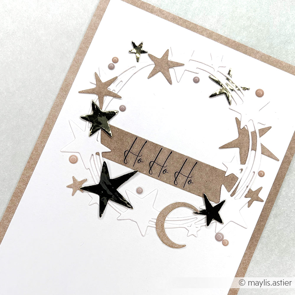 Handgefertigte Karte von Alexandra Renke mit Metallic-Sternen, einer Mondsichel und dem Text "Ho Ho Ho" auf weißen und braunen Designpapieren, die mit Stanzsystemen für zusätzliche Details gefertigt wurden.