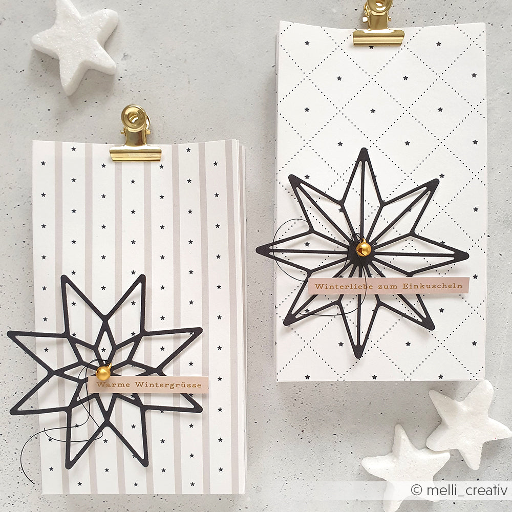 Zwei gemusterte Karten von Alexandra Renke mit schwarzen Stern-Ornamenten und deutschen Wintergrüßen, hergestellt mit Motivstanze Achterstern und Designpapieren, verziert mit weißen Stern-Akzenten.