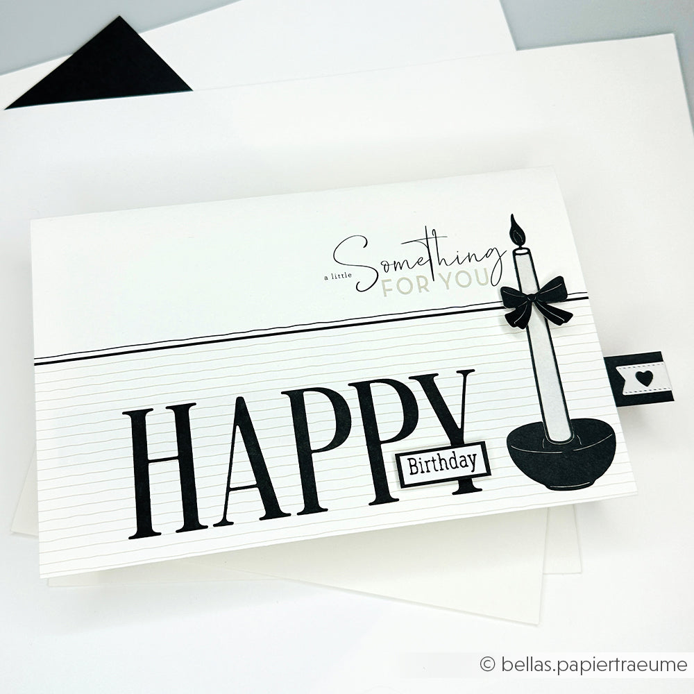 Schwarz-weiße Geburtstagskarte mit Kerze, Schleife und großem Text HAPPY Birthday auf liniertem Hintergrund - gestaltet mit dem Motivstanze Schmales Kerzen-Set von Alexandra Renke und eleganten Designpapieren für eine einzigartige Note.