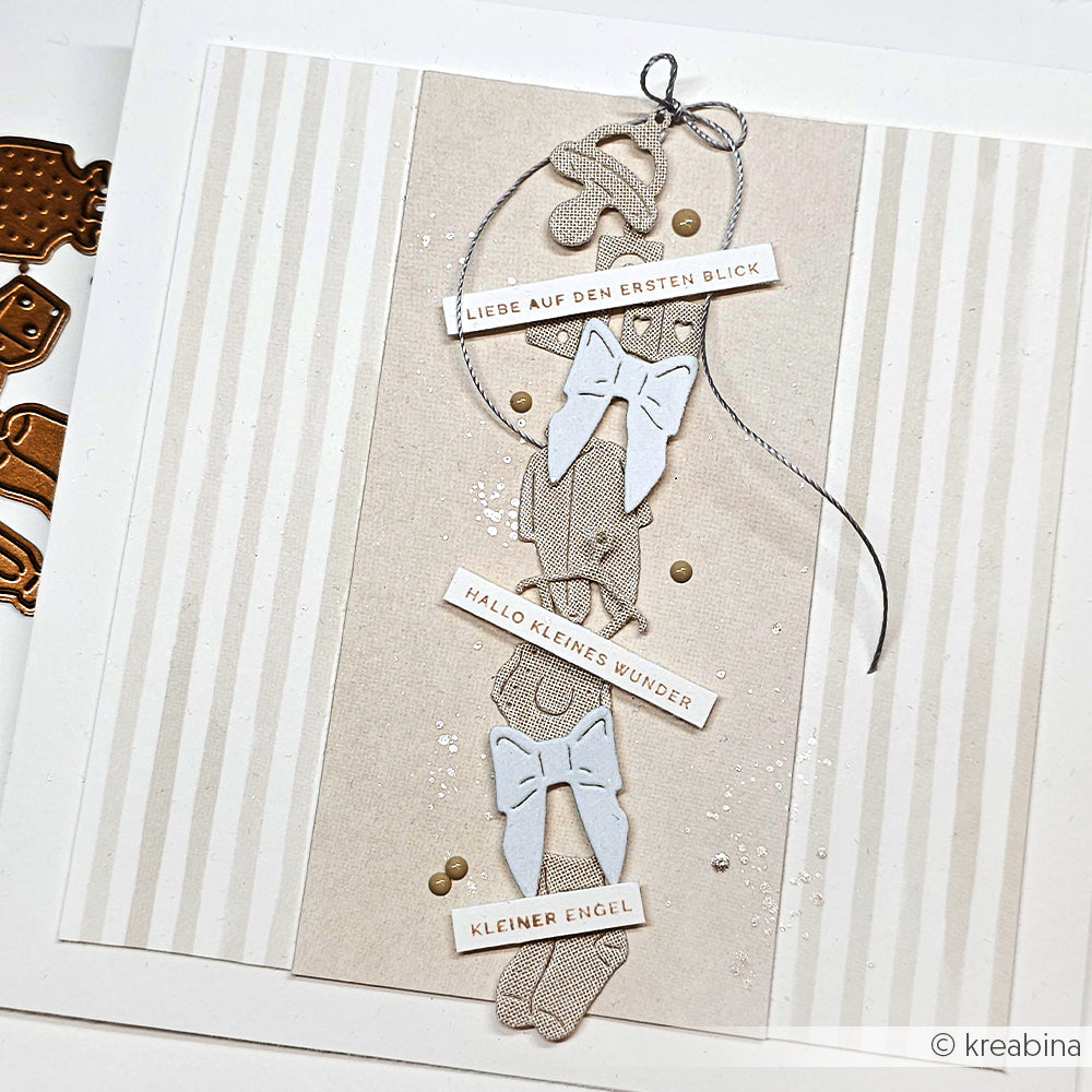 Handgefertigte Karte von Alexandra Renke mit drei weißen Schleifen, deutschen Textstreifen und einem neutral gestreiften, strukturierten Hintergrund - hergestellt mit feinen Designpapieren und veredelt mit DieCut Systemen für einen eleganten Touch.