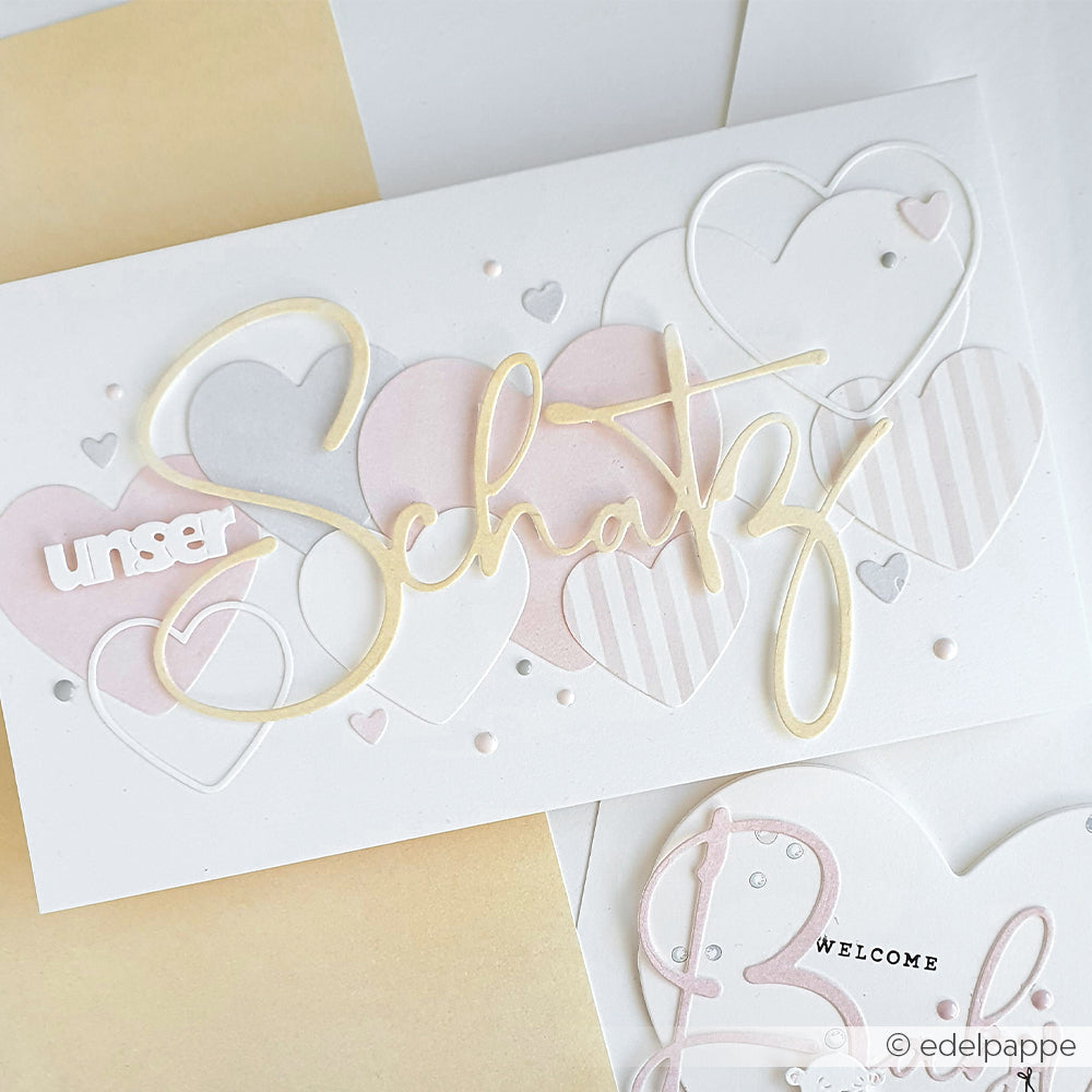 Grußkarte von Alexandra Renke mit pastellfarbenen Herzen, "unser Schatz" in Schreibschrift und Punkten auf Weiß - ideal zum Kombinieren mit Designpapieren oder zum Dekorieren mit der Motivstanze Herzrahmen aus der Kollektion Stanzsysteme.