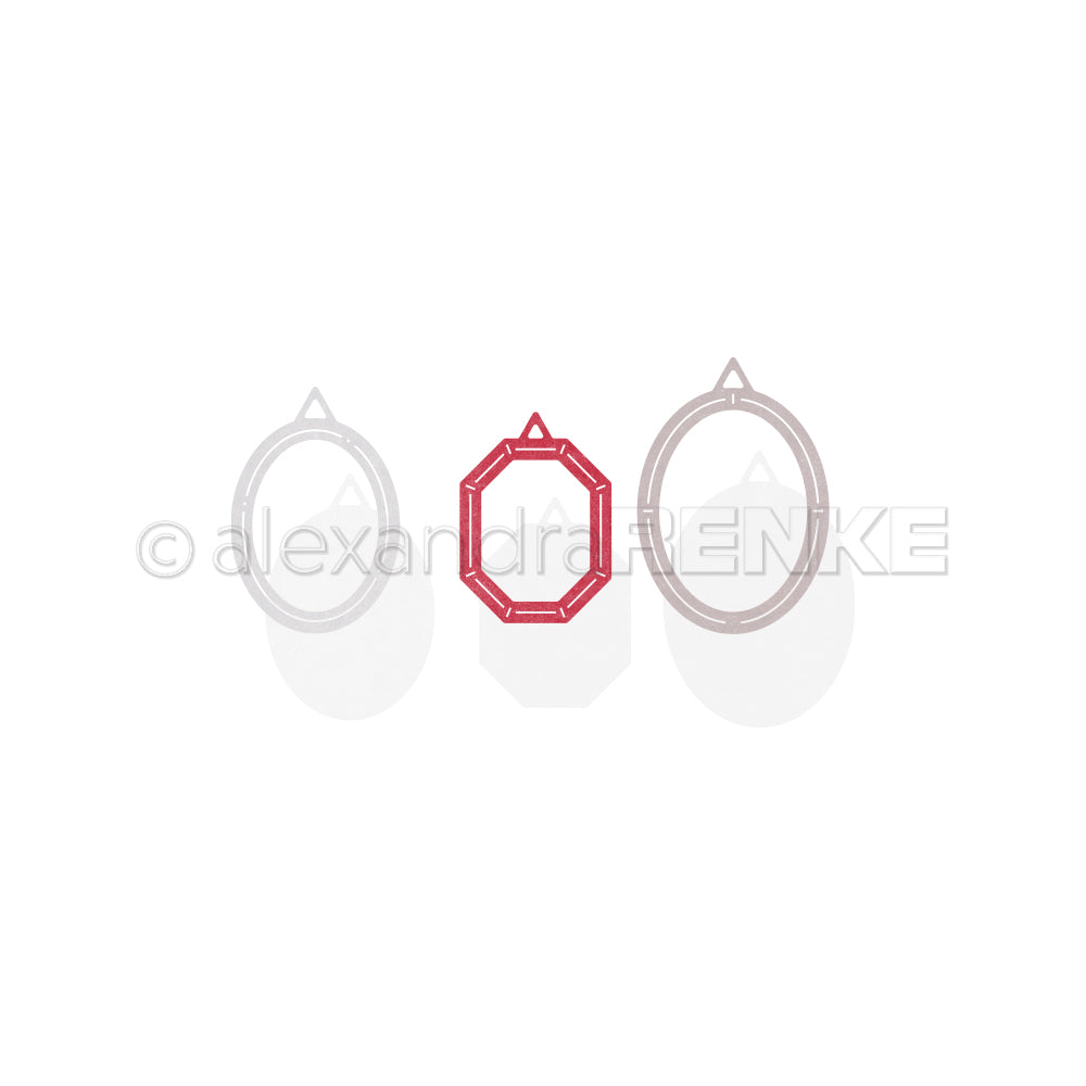 Drei geometrische Rahmen - zwei Ovale und ein rotes Achteck - gestaltet mit Alexandra Renke's Motivstanze Ovale-Rähmchen Stanzsysteme, angeordnet auf weißem Hintergrund. Ideal für kreative Designpapier-Projekte.