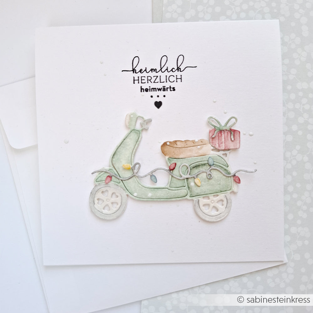 Grußkarte mit einer hellgrünen Roller-Illustration, einem Geschenk und dem Schriftzug Herzlicher Geschenke-Roller.