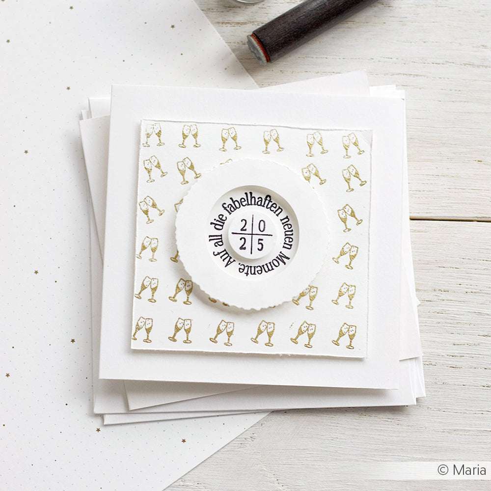 Eine handgefertigte, quadratische Grußkarte von Alexandra Renke mit Mini-Sektgläsern und einer deutschen Botschaft für besondere Anlässe, versehen mit einem Akzent-Stempel für eine einzigartige Note.