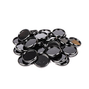 Ein Stapel glänzender, runder schwarzer Alexandra Renke Bindescheiben auf weißem Hintergrund.