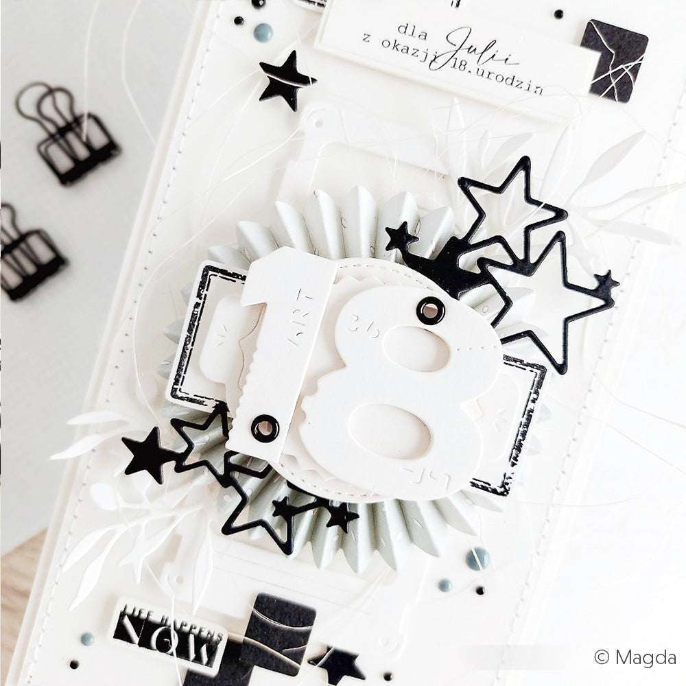 Eine handgefertigte Karte von Alexandra Renke mit der "18" in Weiß, schwarzen Sternen und geschichtetem Dekor in Schwarz und Weiß - ideal als unverwechselbares Minialben-Cover oder für Buchbinden. Veredelt mit Ösen mit Unterlegscheibe für eine elegante Note.