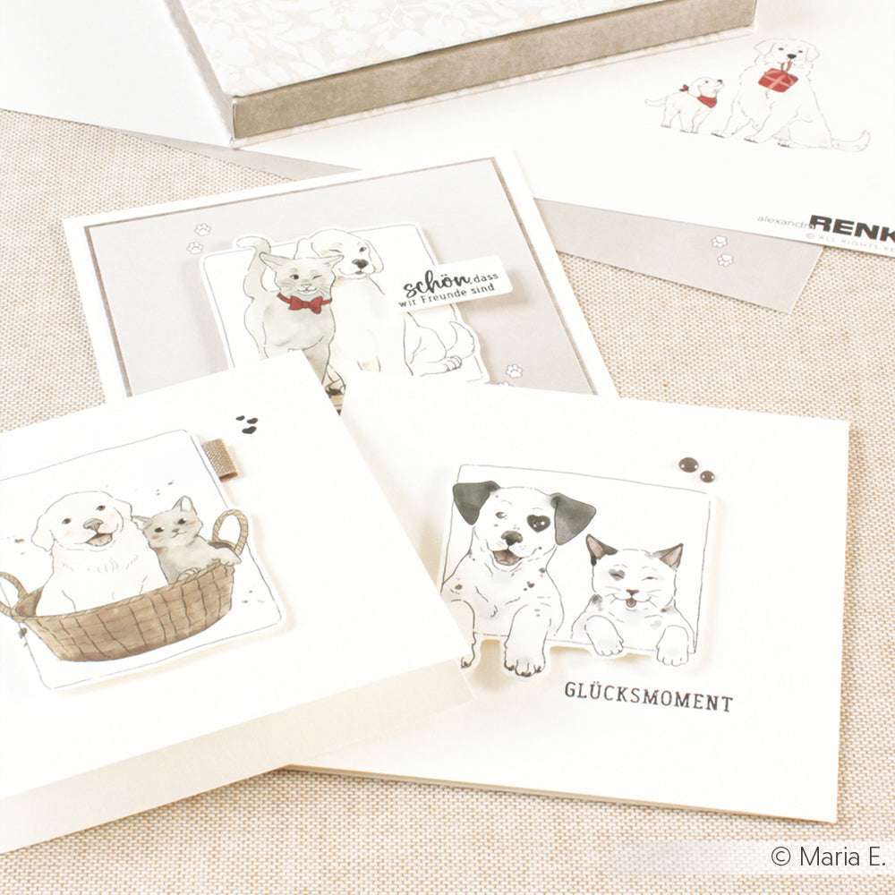Die Grußkarten von Alexandra Renke zeigen niedliche Welpen und Kätzchen in Körbchen auf einem hellbeigen Hintergrund - ideal für Kartenpakete mit Tiermotiven oder in Kombination mit passendem Designpapier.