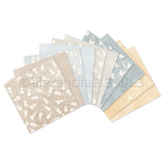 Ein Fächer dekorativer, pastellfarben gemusterter Papierbögen in Beige-, Blau- und Cremetönen von Alexandra Renke - ideal für kreative Inspirationen oder Ihr nächstes Bastelbündel.