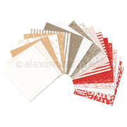 Eine fächerförmige Präsentation verschiedener gemusterter Scrapbook-Papierbündel in Beige-, Weiß- und Rottönen.