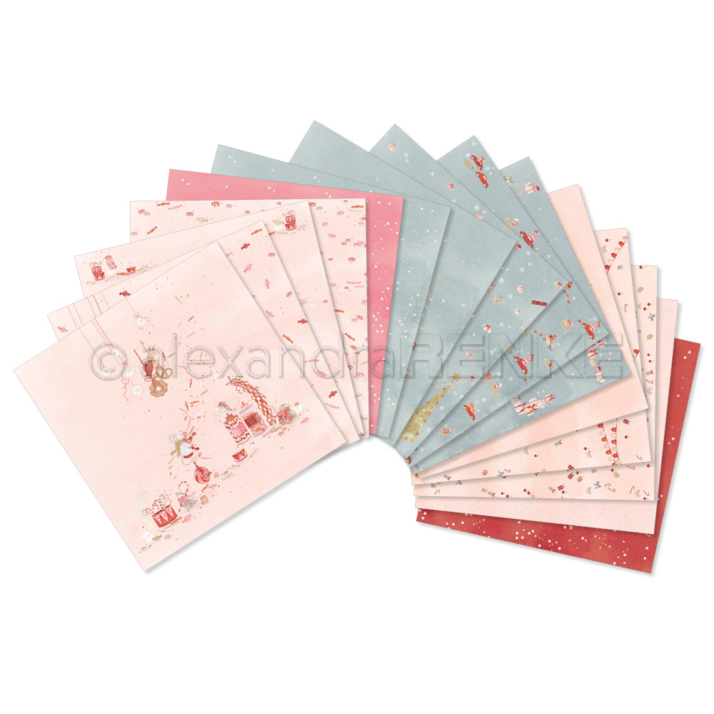 Ein Fan der gemusterten Papierbögen aus dem „Kreativität“-Paket mit weihnachtlichen Motiven in Rosa-, Blau- und Rottönen als Inspiration für die Feiertage.