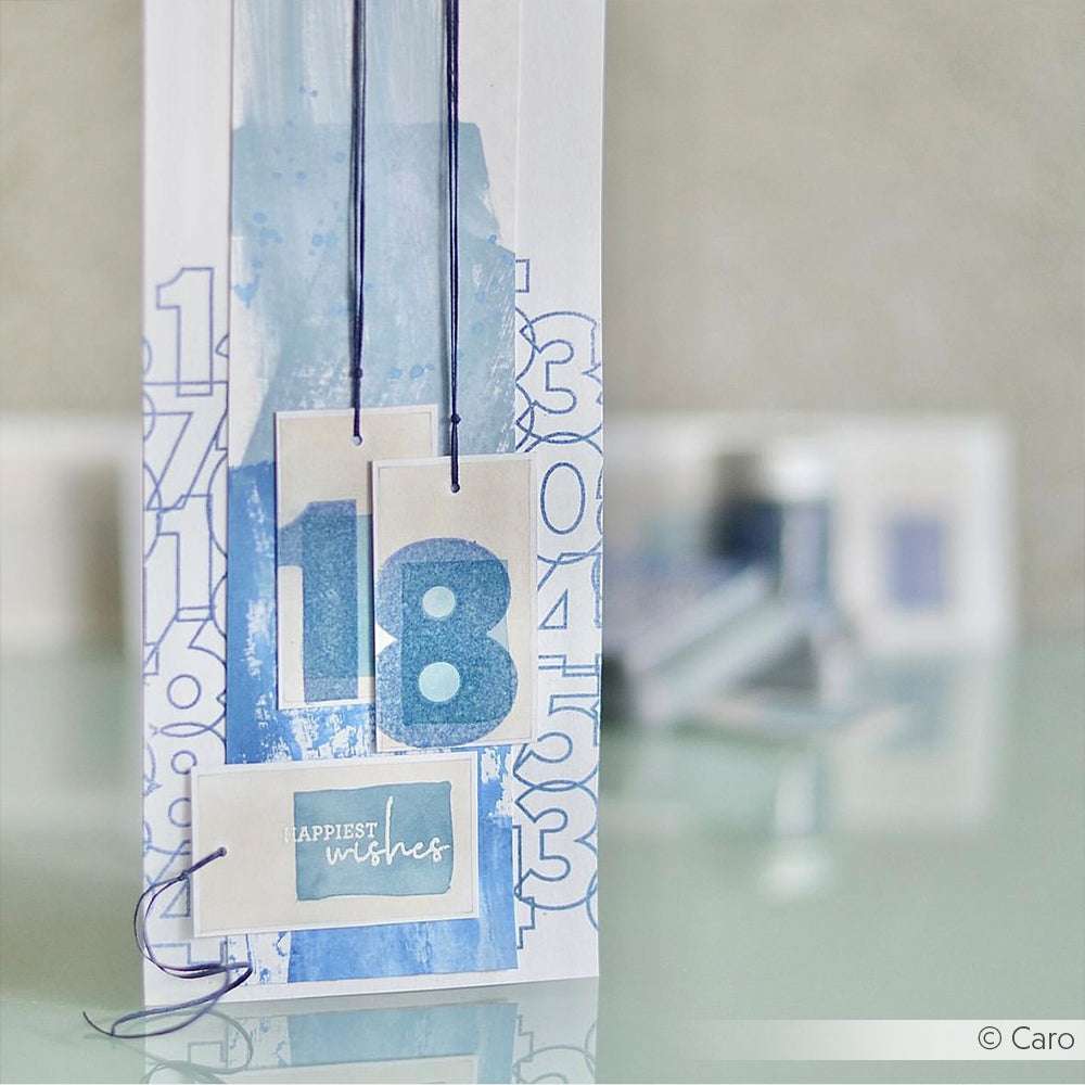 Große Geburtstagskarte von Alexandra Renke mit blauer Aquarellfarbe, den Fette Zahlen "18" und "Herzlichen Glückwunsch" auf der Vorderseite. Ideal zum Gestalten mit Ihrem bevorzugten Clear Stamp Set oder Photopolymer Stempel.