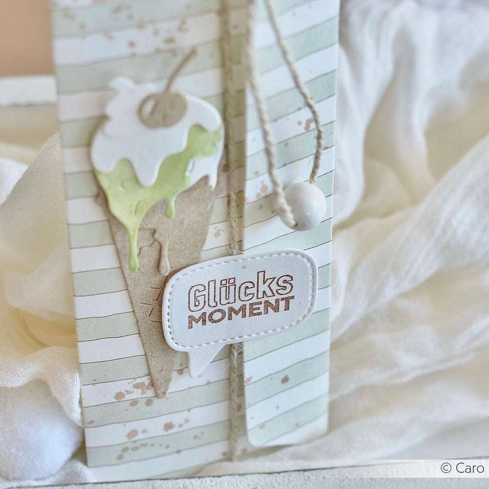 Handgefertigte Karte von Alexandra Renke mit Eiscreme-Motiv und "Glücksmoment" auf gestreiftem Papier, gestaltet mit einem hochwertigen Klarsichtstempelset.