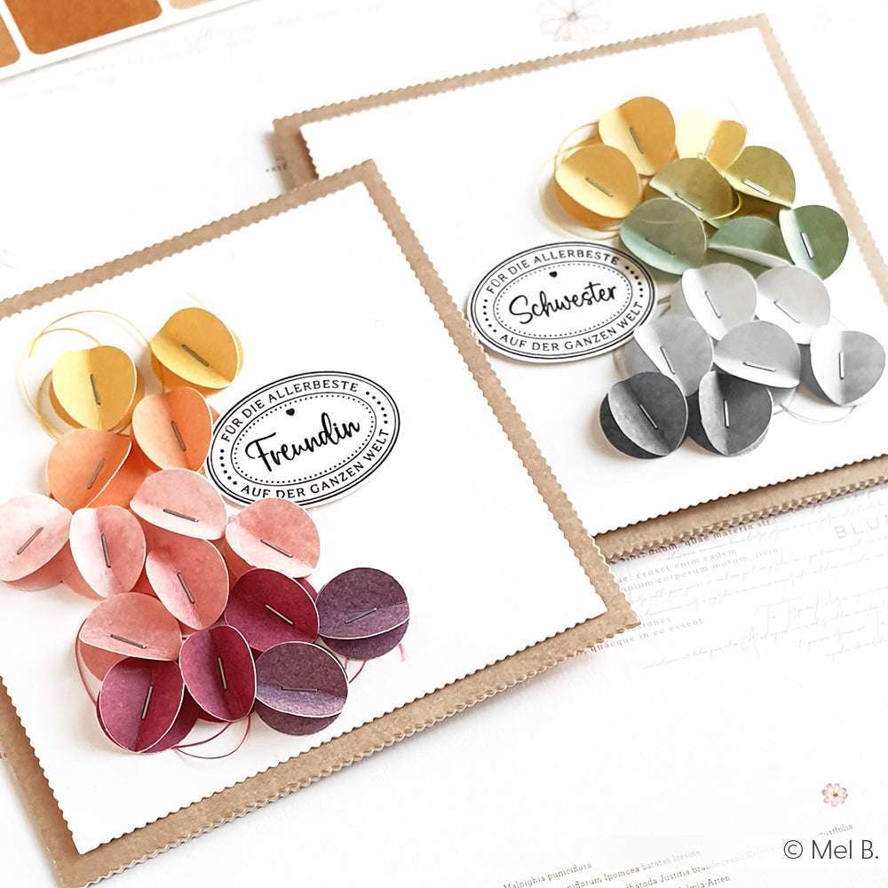 Zwei handgefertigte Grußkarten von Alexandra Renke mit geschichteten Papierkreisen in Farbverläufen und deutschem Clear Stamp Text auf klarem weißen Hintergrund - ideal für einzigartige Papierprojekte.