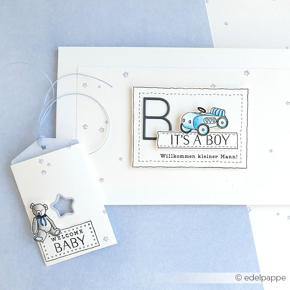 Grußkarte und Geschenkanhänger von Alexandra Renke mit dem Text "It's a Boy", blauem Spielzeugauto, Teddybär und Sternen auf weißem Untergrund - ideal für die Kombination mit Ihren Lieblingsmotiven von Clear Stamp oder Photopolymer Stempel.