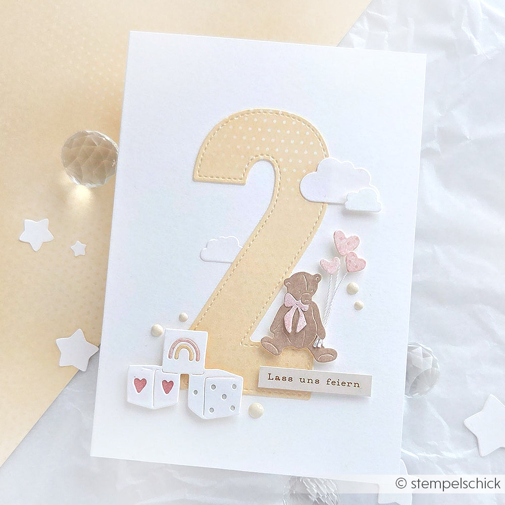 Geburtstagskarte von Alexandra Renke mit einer großen Zahl 2, einem Teddybär, Wolken, Luftballons und pastellfarbenen Dekorationen auf weißem Hintergrund mit charmanten DieCut System-Details für einen bezaubernden Touch.