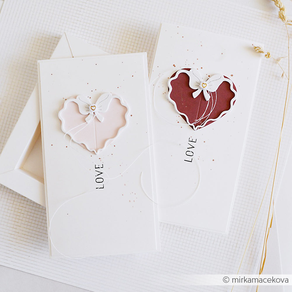 Zwei elegante handgefertigte Karten von Alexandra Renke mit Herzausschnitten, floralen Akzenten und "LOVE" auf weißem Hintergrund - perfekt für die Verwendung von Stanzen für Designpapier oder DieCut Systemen.