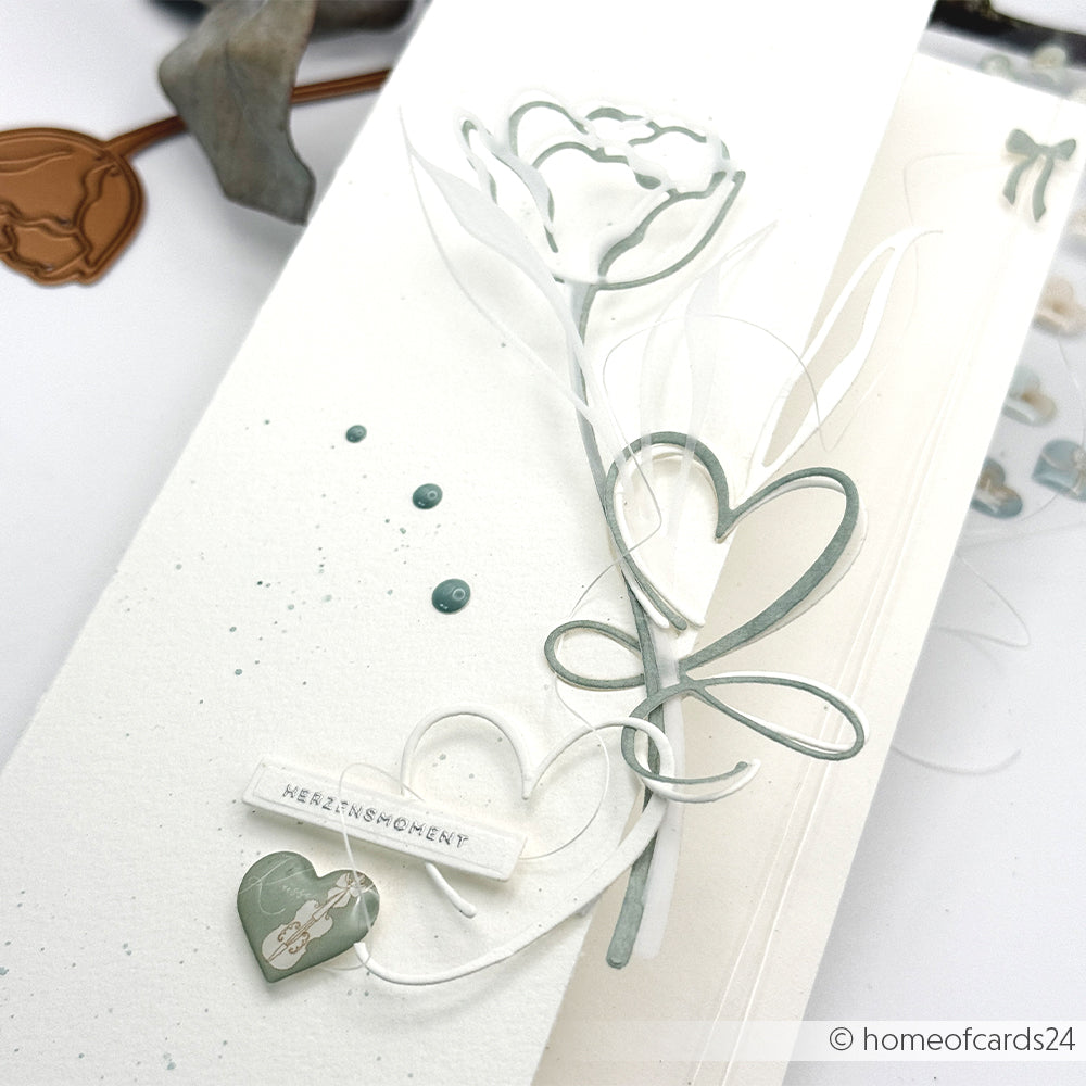 Handgefertigte Karte von Alexandra Renke mit zartem Blumen- und Herzmotiv in zartem Grün, hergestellt mit Motivstanze Lineart Kelchblume und feinen Designpapieren, veredelt mit dem Label "Herzensmensch".