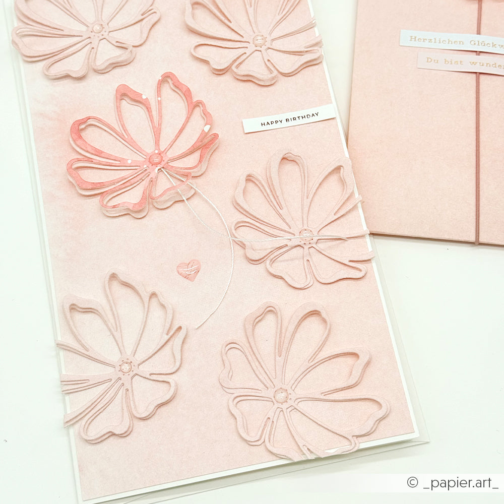 Handgefertigte Geburtstagskarte von Alexandra Renke mit zartrosa Blumenmotiven aus hochwertigen Designpapieren, einem zartrosa Hintergrund, einem "Happy Birthday"-Schriftzug und mit der Motivstanze Gartenblume gestalteten Details.