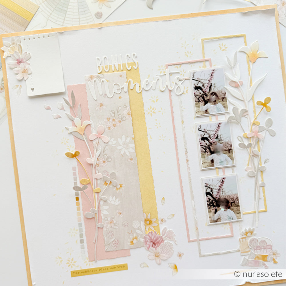 Eine Scrapbook-Seite mit floralen Verzierungen, Pastelltönen, dem Schriftzug „Bonitos Momentos“, drei kleinen Fotos im Vintage-Stil und detailreichen Akzenten, die mit Designpapieren von Alexandra Renke und einer Motivstanze gestaltet wurden.