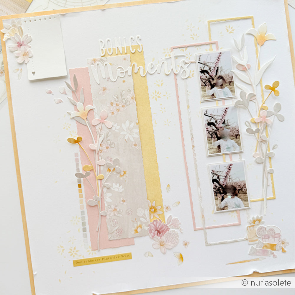Eine Seite in Pastelltönen für ein Scrapbook mit Blumenmotiven, gestaltet mit Designpapieren von Alexandra Renke, „Bonitos Moments“-Schriftzügen, Akzenten mit der Stanze „Blütenkomposition“ und vier kleinen Fotos im Vintage-Stil.