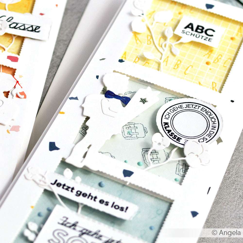 Nahaufnahme einer handgefertigten Karte mit Schuldekor, bunten 200g Designpapieren und mit Stanzen für DieCut Systeme gestanzten Akzenten - alles von Alexandra Renke.