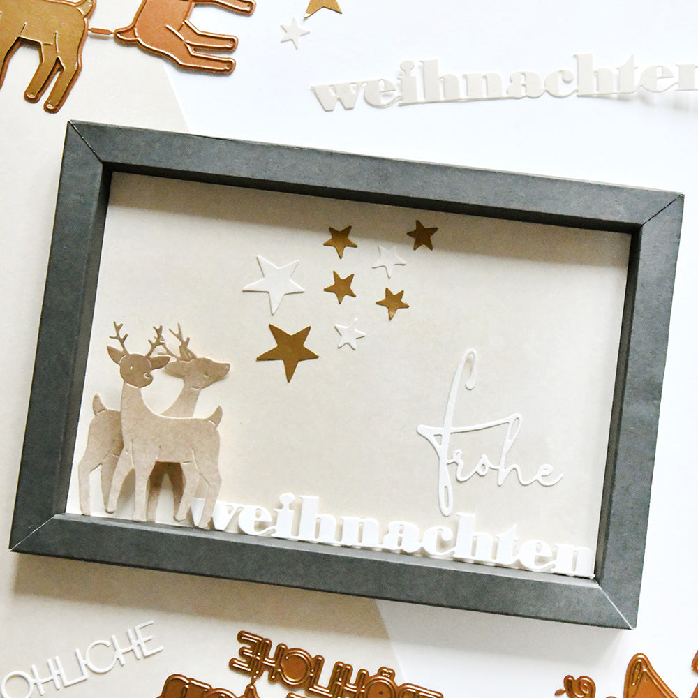 Schattenbox von Alexandra Renke mit zwei Rentieren, goldenen Sternen und "frohe weihnachten" auf dem Glas, gefertigt mit der Motivstanze Weihnachten und festlichen Designpapieren - ein charmantes Weihnachtsdekorationsstück.