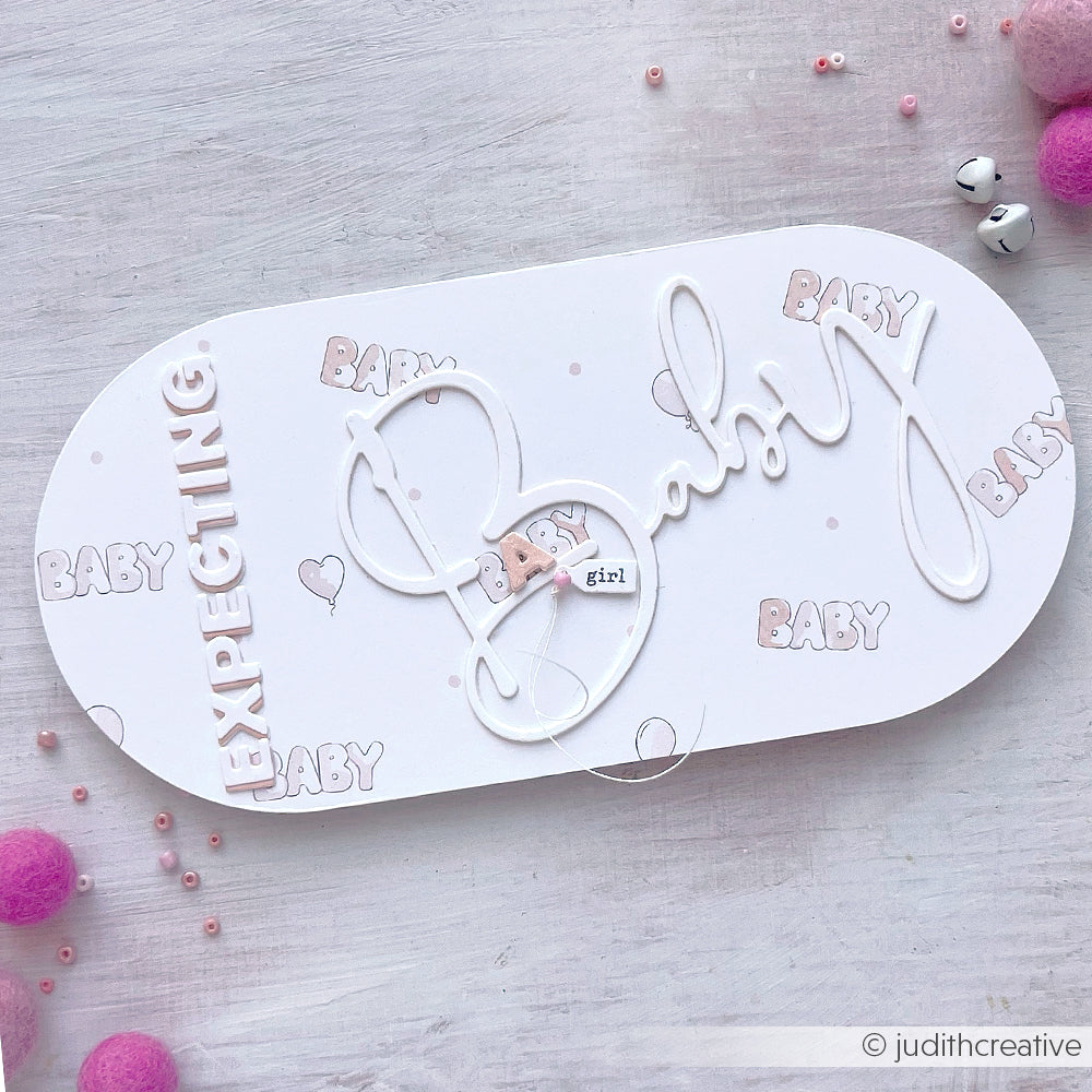 Ovale Baby Shower Karte von Alexandra Renke mit "EXPECTING" und "Baby" Text in zartem Rosa und Weiß, umgeben von kleinen Herzen. Das DieCut-System sorgt für präzise Formen - perfekt, um Ihrer Feier eine süße Note zu verleihen.