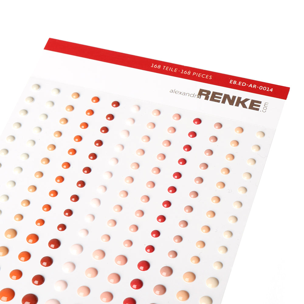 Ein Bogen Alexandra Renke Enamel Dots für die Kartengestaltung mit roten, orangefarbenen und pfirsichfarbenen Aufklebern, die in sauberen Reihen angeordnet sind.