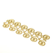 Ein stilvolles Goldarmband von ☆ mit einem sich wiederholenden Fahrradmuster auf weißem Hintergrund - ein auffälliges Dekoelement für jede Schmucksammlung.