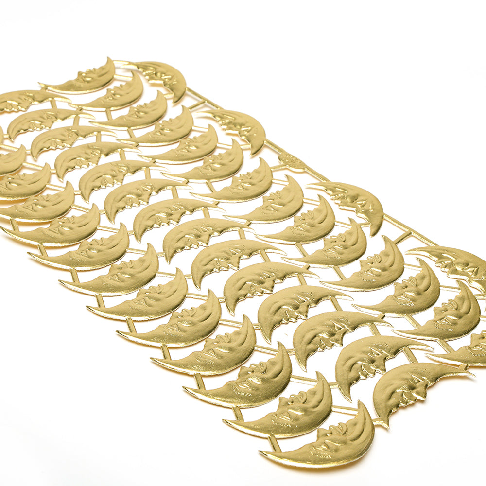 Goldfarbene Mondsichelgesichter, fein säuberlich auf weißem Hintergrund angeordnet, ergeben charmante Dekoelemente oder Figurinen von ☆ für Ihre Papierarbeitsprojekte.