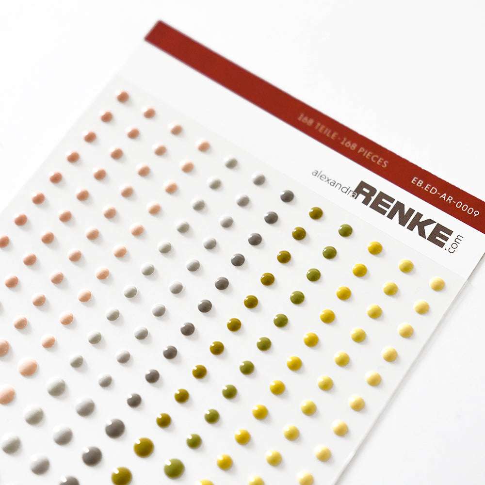 Bogen mit bunten Emaille-Punkten von Alexandra Renke in fröhlichen Farben und verschiedenen Größen, aufgereiht zur kreativen Kartengestaltung, mit Branding am oberen Rand.