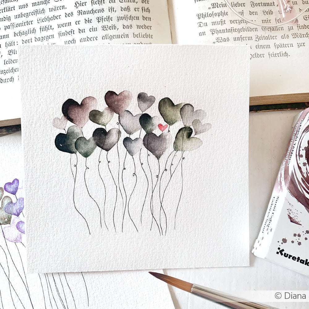 Aquarellmalerei von herzförmigen Ballons, meist dunkel mit einem rosa auf weißem Papier, erstellt mit Kuretake Gansai Tambi Aquarellfarben für satte Töne.