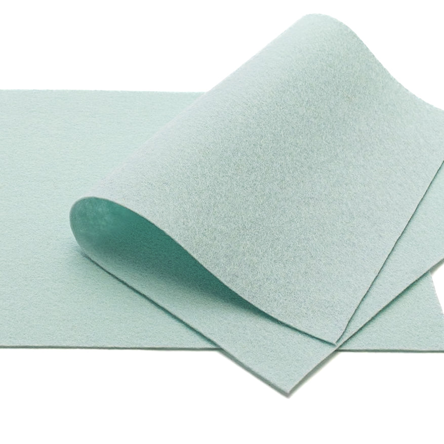 Ein Stück hellblauer ☆ Bastelfilz, das auf einer flachen weißen Unterlage teilweise umgeschlagen ist.
