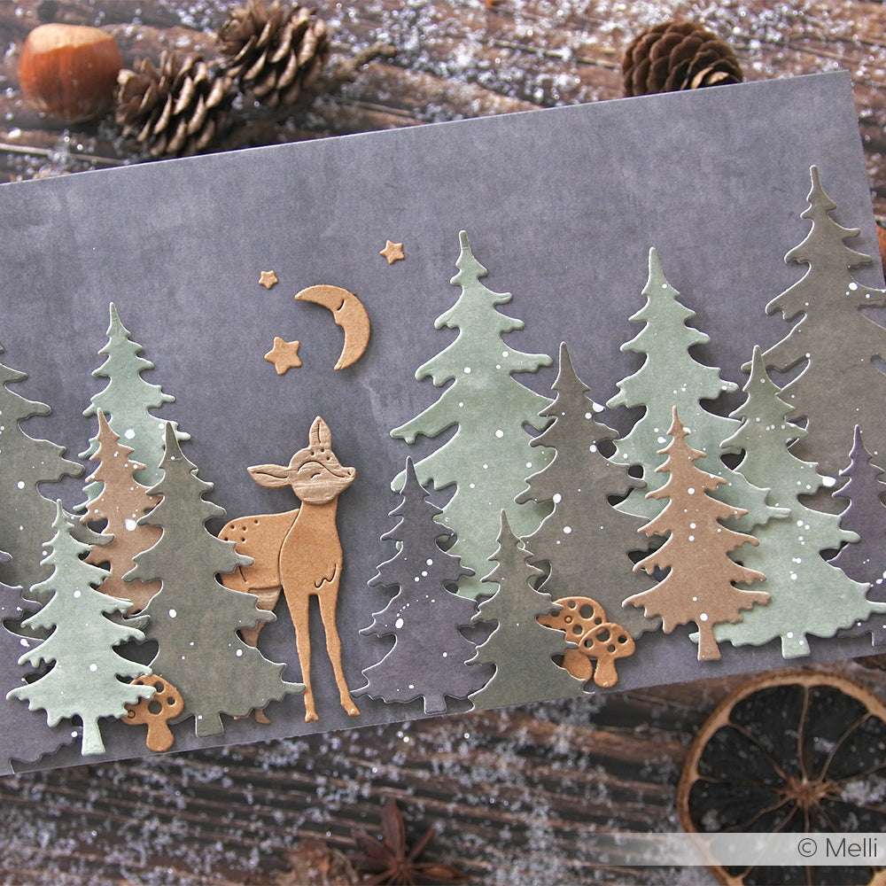 Handgemachte Karte von Alexandra Renke mit einem Reh, Bäumen, Pilzen, Sternen und einem Mond auf einem rustikalen Holzhintergrund mit Tannenzapfen. Die Ausschnitte wurden mit Motivstanze und Stanzsystemen hergestellt.