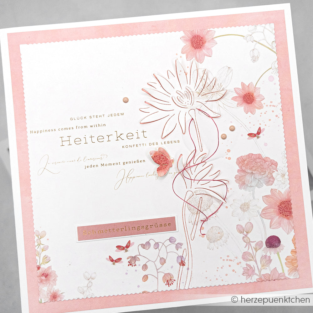 Quadratische Karte von Alexandra Renke mit rosa Blumen, Schmetterlingen und deutschem Text, mit zarten Blumen- und Schmetterlingsmotiven, die mit DieCut Systemen und Motivstanze Negativ-Blume 7 hergestellt wurden.