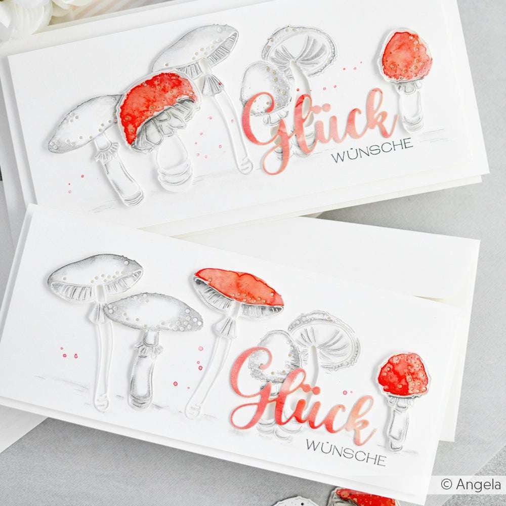Zwei handgefertigte Karten mit Alexandra Renke Motivstanze Glückspilz Duo 2 Dies zeigen illustrierte Pilze und Glückswünsche in Rot und Grau auf knackig weißem Hintergrund.