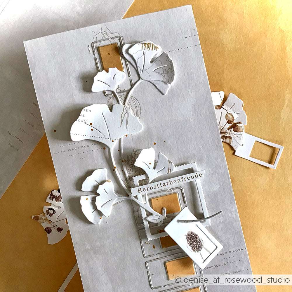 Handgemachte Karte von Alexandra Renke mit weißen Blumen, deutschem Text und ausgeschnittenen Rahmen auf hellem Hintergrund, verziert mit Deep Edge Motivstanzen und PAPPcut®ies.