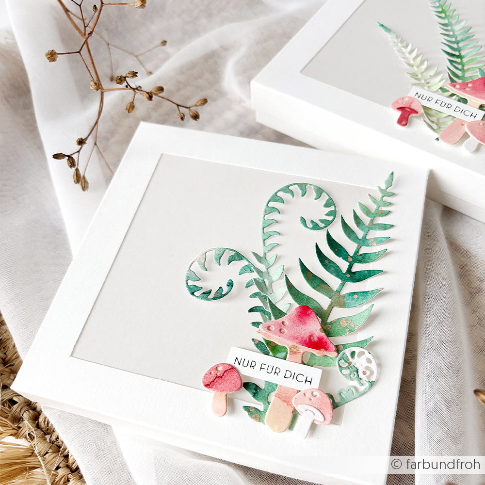 Weiße Kartonkarte mit Aquarellpilzen, Farnmotiven, die mit Motivstanzen gestaltet wurden, und einem kleinen Etikett mit der Aufschrift „NUR FÜR DICH“. Ideal, um mit der Motivstanze „Farn Paar“ oder Stanzsystemen zarte Details hinzuzufügen.