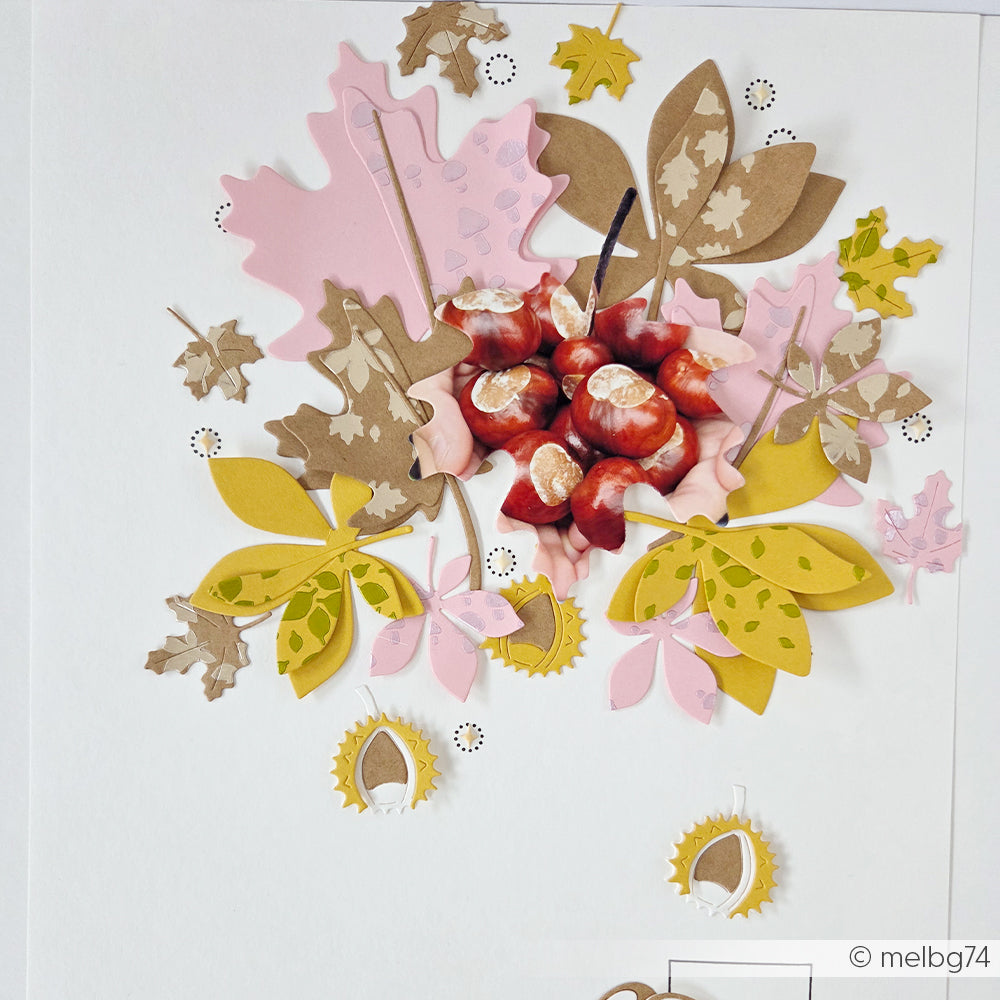 Eine Collage aus Kastanien und bunten Papierblättern in Gelb, Rosa und Braun auf weißem Hintergrund, gestaltet mit dem Motivstanze-Kastanien-Set und mit Designpapier-Stanzteilen für zusätzliche Details verziert.