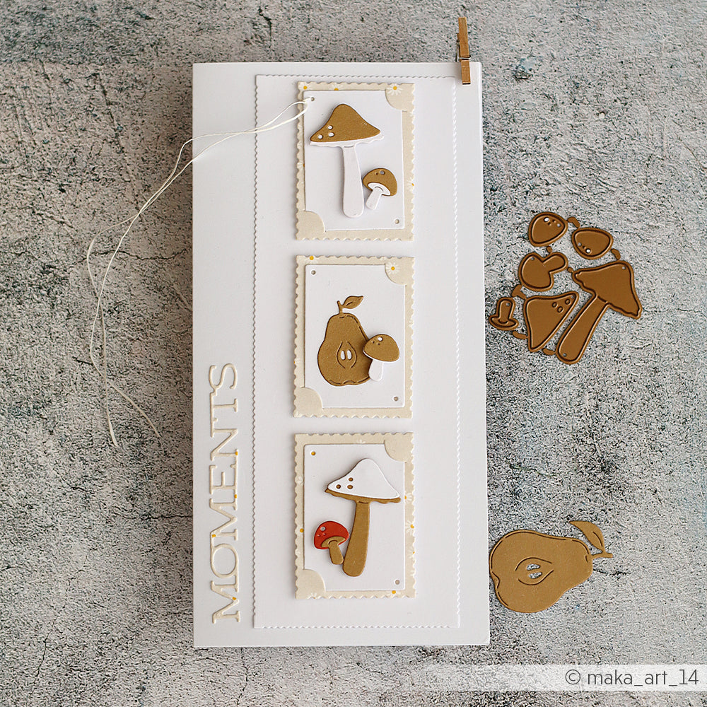 Weiße Karte aus edlem Designpapier mit drei ausgestanzten Motiven, die mit der Motivstanze „Pilz Trio“ gestaltet wurden, sowie einer Birne mit der Aufschrift „MOMENTS“ auf grauem, strukturiertem Untergrund.