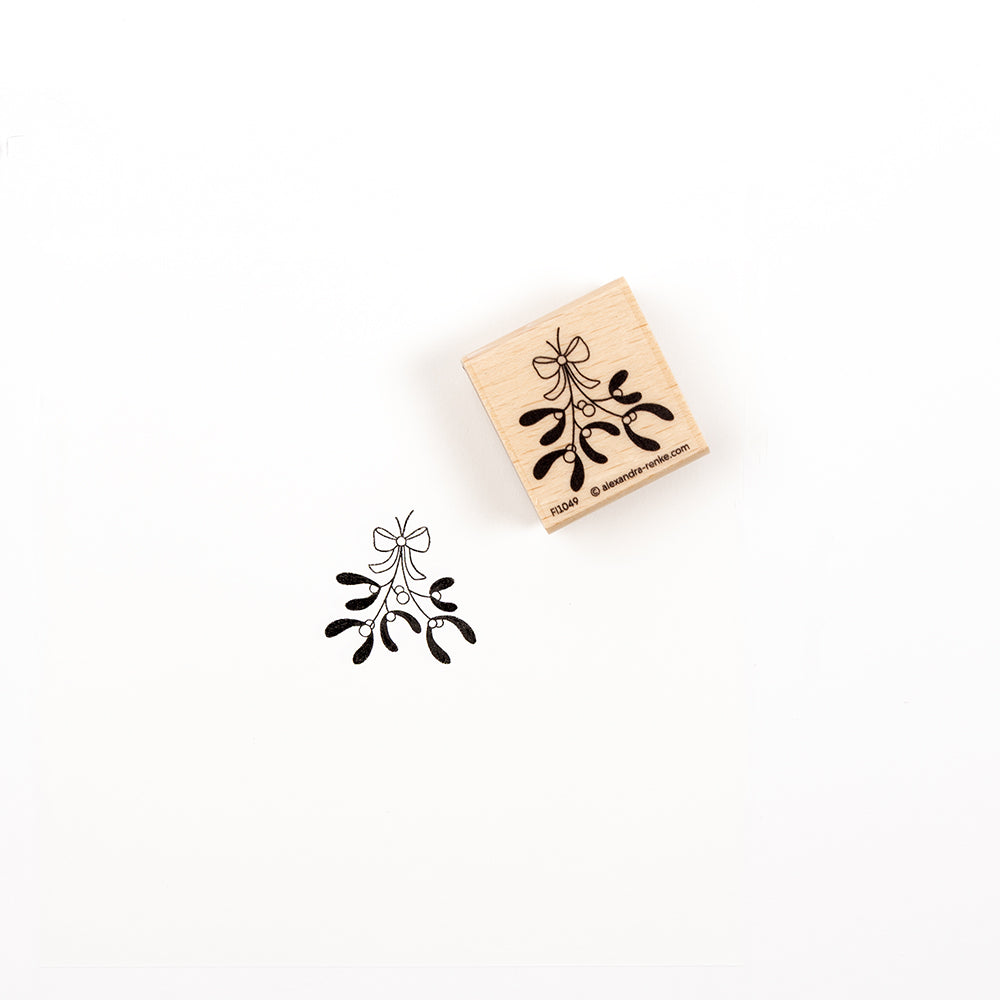 Ein „Mistelzweig“-Stempel mit einem Mistelzweig-Motiv neben dem Stempelabdruck auf weißem Hintergrund.