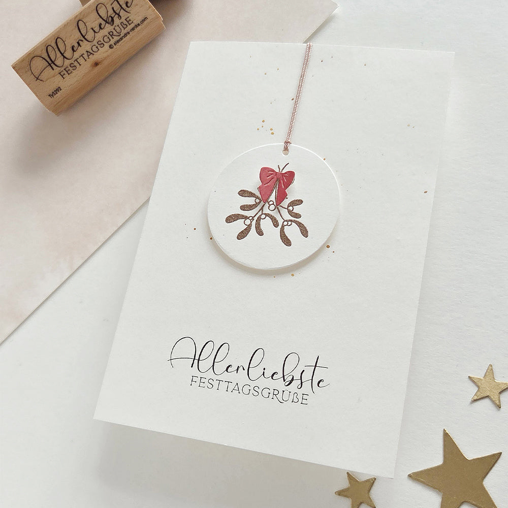 Grußkarte mit einem Mistelzweig-Motiv und dem Text Allerliebste Festtagsgrüße.