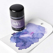 Eine Flasche Lindy's Stamp Gang Magical Shakers mit hochpigmentiertem Pulver und einem Anhänger mit einem lila Aquarellmuster - ideal für Papierprojekte.