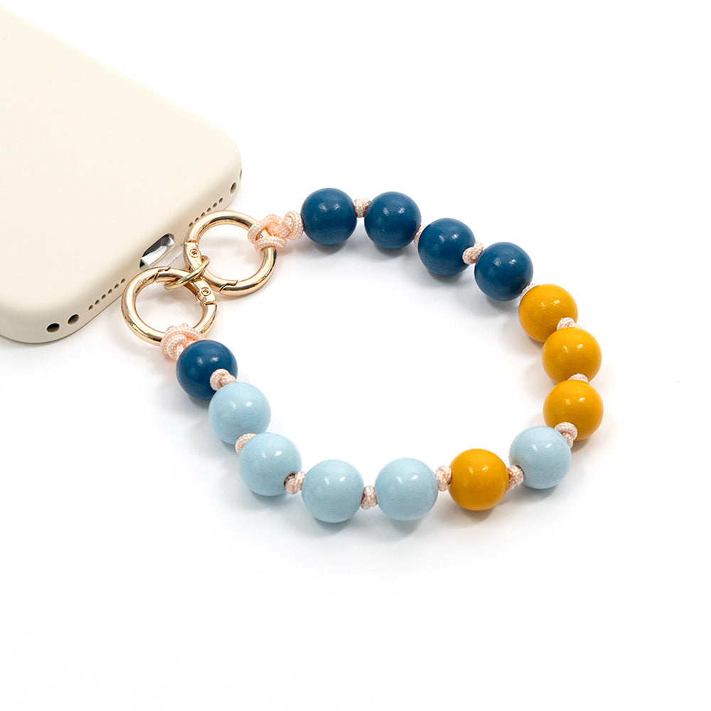 Handyhülle von ☆ mit einer Perlen-Handschlaufe aus strapazierfähigem Nylon in Blau, Hellblau und Gelb, die mit goldenen Ringen befestigt ist.