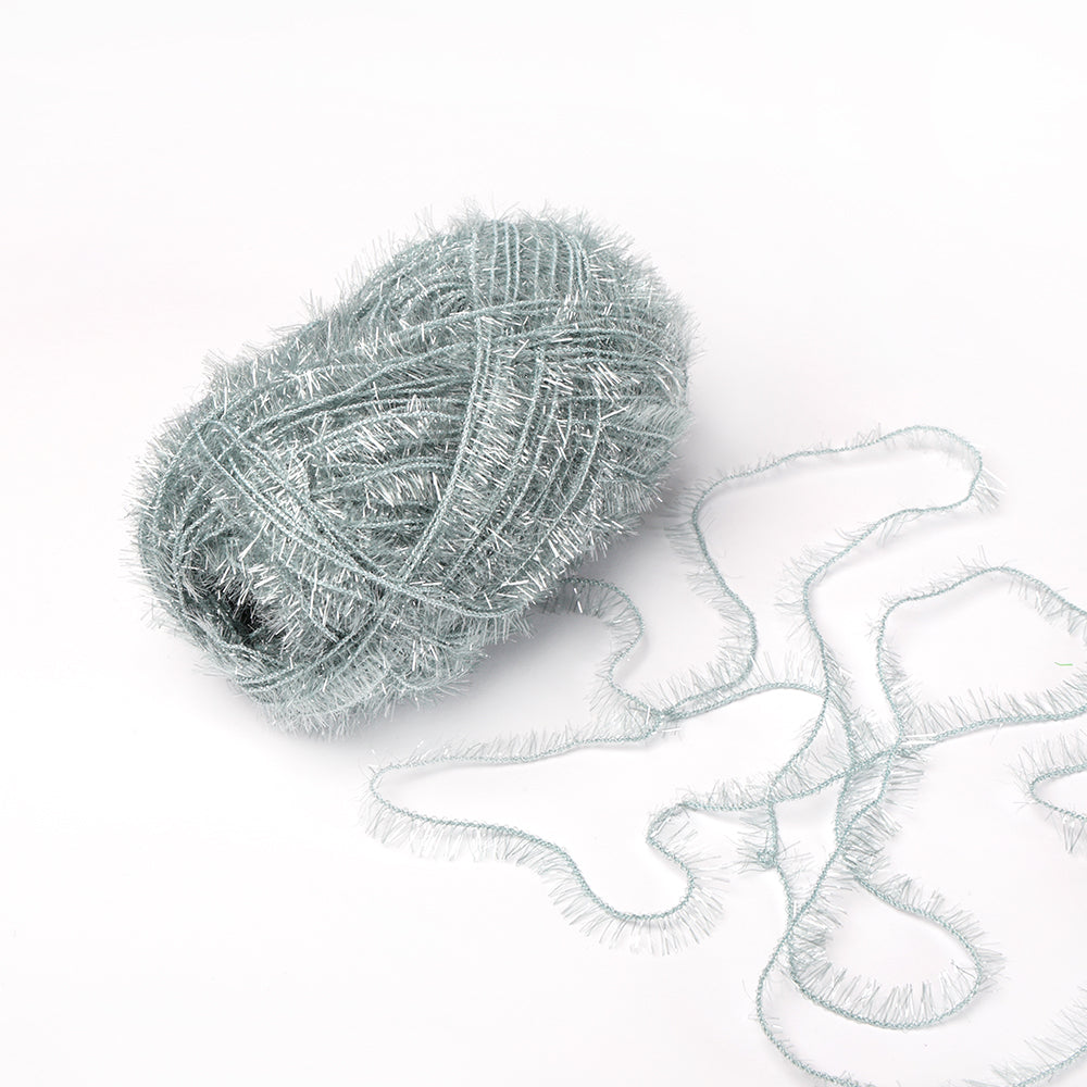 Ein Knäuel hellblaues, flauschiges Rico Design Creative Bubble Garn mit einigen Strängen, die sich auf weißem Grund auflösen - ideal zum Häkeln von Geschirrtüchern oder anderen kreativen Projekten.