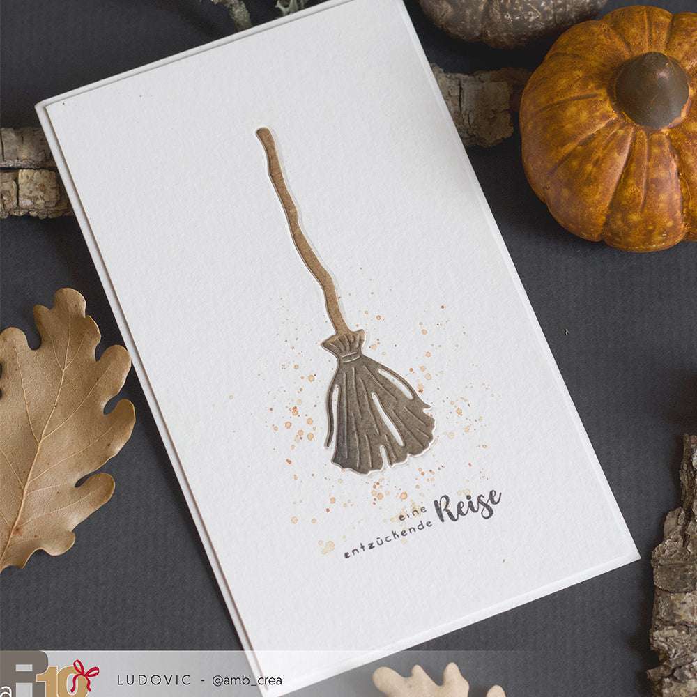Grußkarte von Alexandra Renke mit einer Besen-Illustration, Herbstlaub und einem kleinen Kürbis - ideal für Fans von Motivstanze Hexenzubehör oder DieCut Systeme Stanzen.